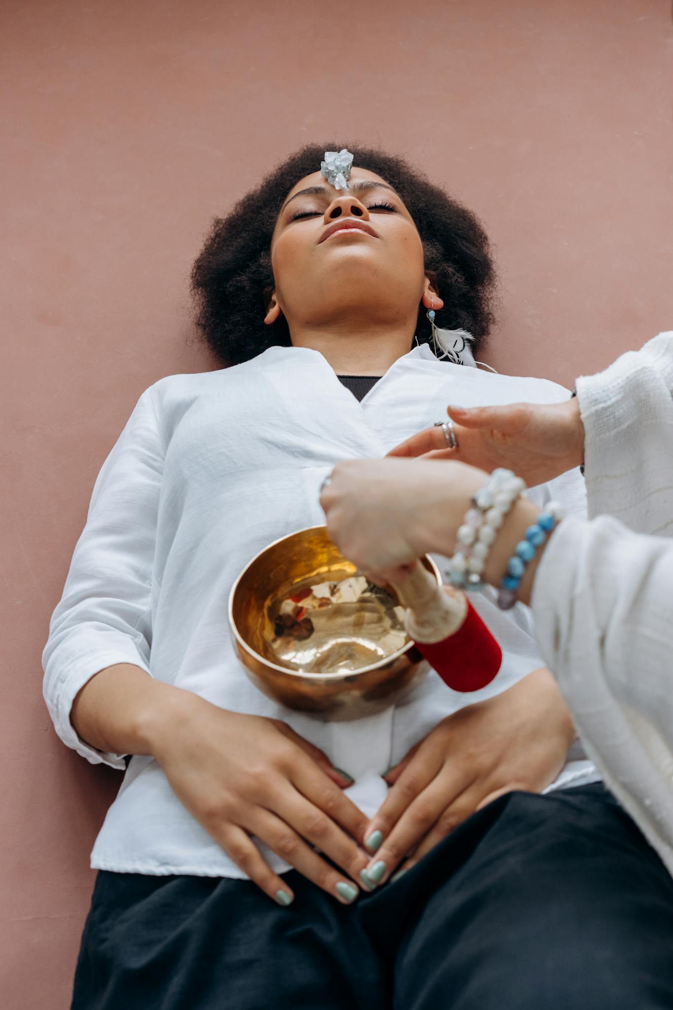 A Woman Experiences Crystal Healing Therapy With